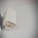 A picture of a white outdoor speaker