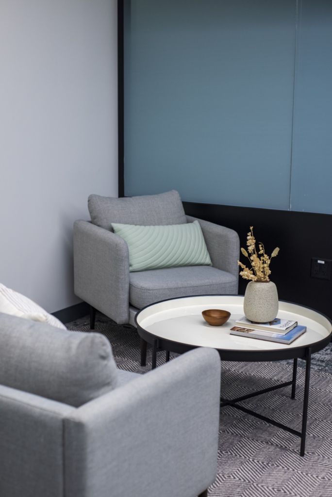 A picture of a room with pillows that are different shades of blue