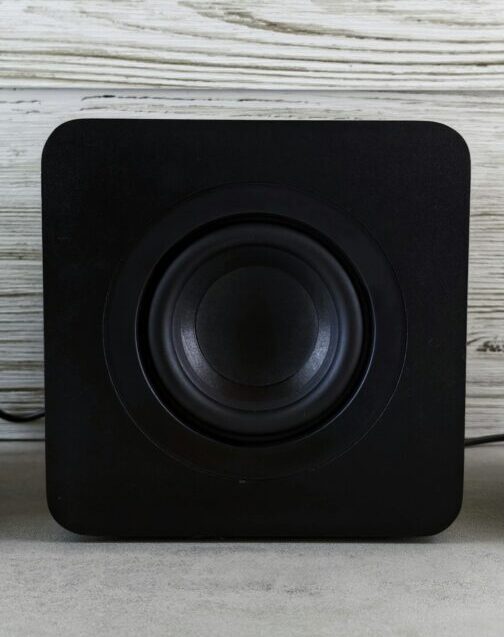 A picture of a black subwoofer on a light background for illustrative purposes for an article titled "why is my subwoofer not working?"